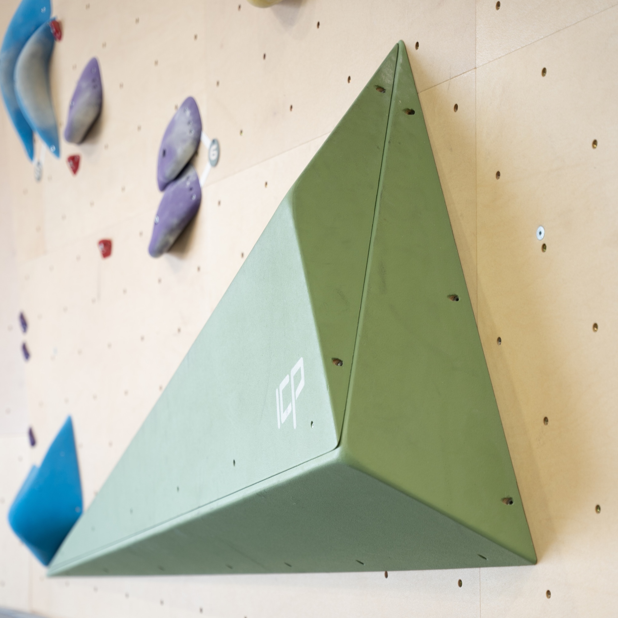 Grace.G2.2.L_ICP Volume - Climb ICP Shop Australia Two Grace.G2.2.L ICP Volumes in green, mounted on a wood-textured bouldering wall.