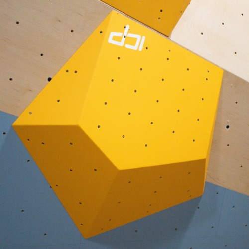 Large yellow ICP Ian I1.1 L climbing volume spanning wood-textured and grey wall surfaces, positioned for integration with the ICP Raps system.