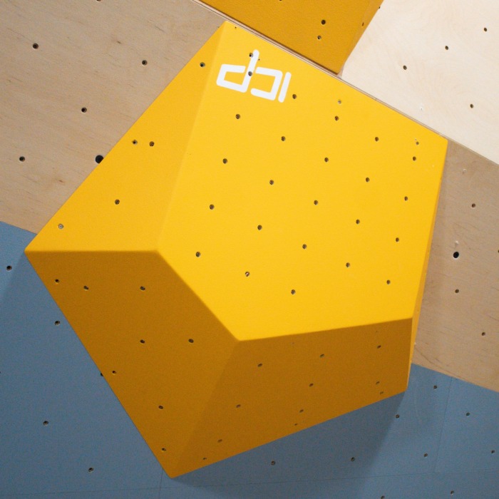 Large yellow ICP Ian I1.1 L climbing volume spanning wood-textured and grey wall surfaces, positioned for integration with the ICP Raps system.