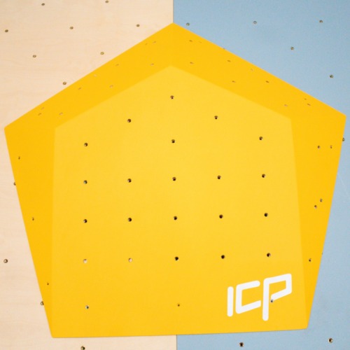 Large yellow ICP Ivy I2.1 L climbing volume with t-nuts, mounted on a grey textured wall to create bold and dynamic route features.