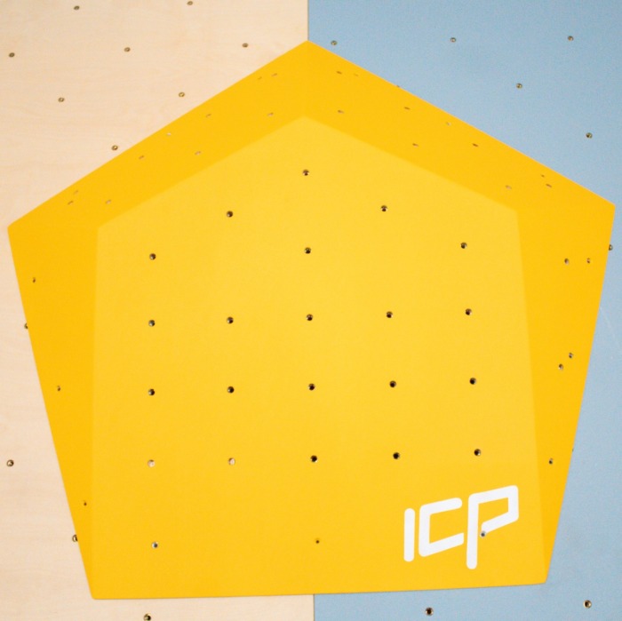Large yellow ICP Ivy I2.1 L climbing volume with t-nuts, mounted on a grey textured wall to create bold and dynamic route features.