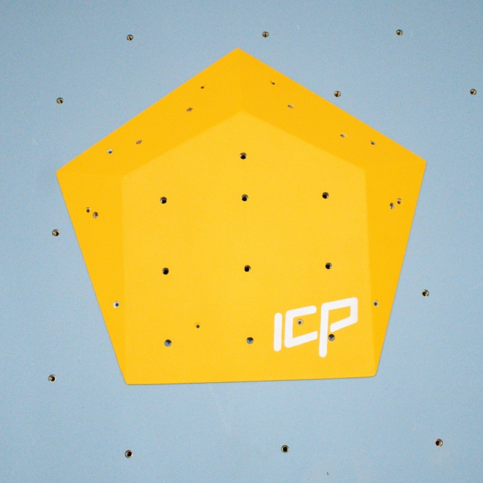 Small yellow ICP Ivy I2.2 S climbing volume with multiple t-nuts, fixed to a grey textured climbing wall for versatile hold placement.