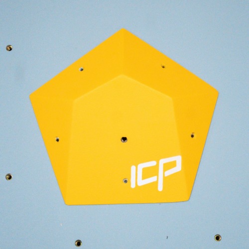 Compact yellow ICP Ivy I2.3 XS climbing volume mounted on a grey textured wall, enhancing technical route features.