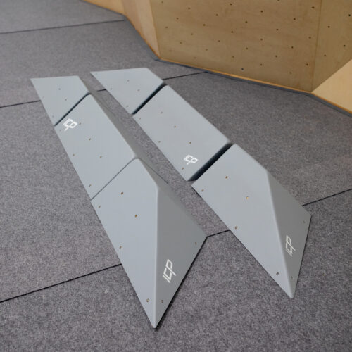 Two complete grey ICP Harry H2.1-2-3 XL climbing volume sets with t-nuts, displayed on safety matting showing all three components of each set before wall installation.