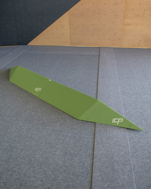 Large green ICP Harry H2.4-5 L thin rail climbing volume pair with t-nuts, mounted on a wood-textured wall for technical route setting.
