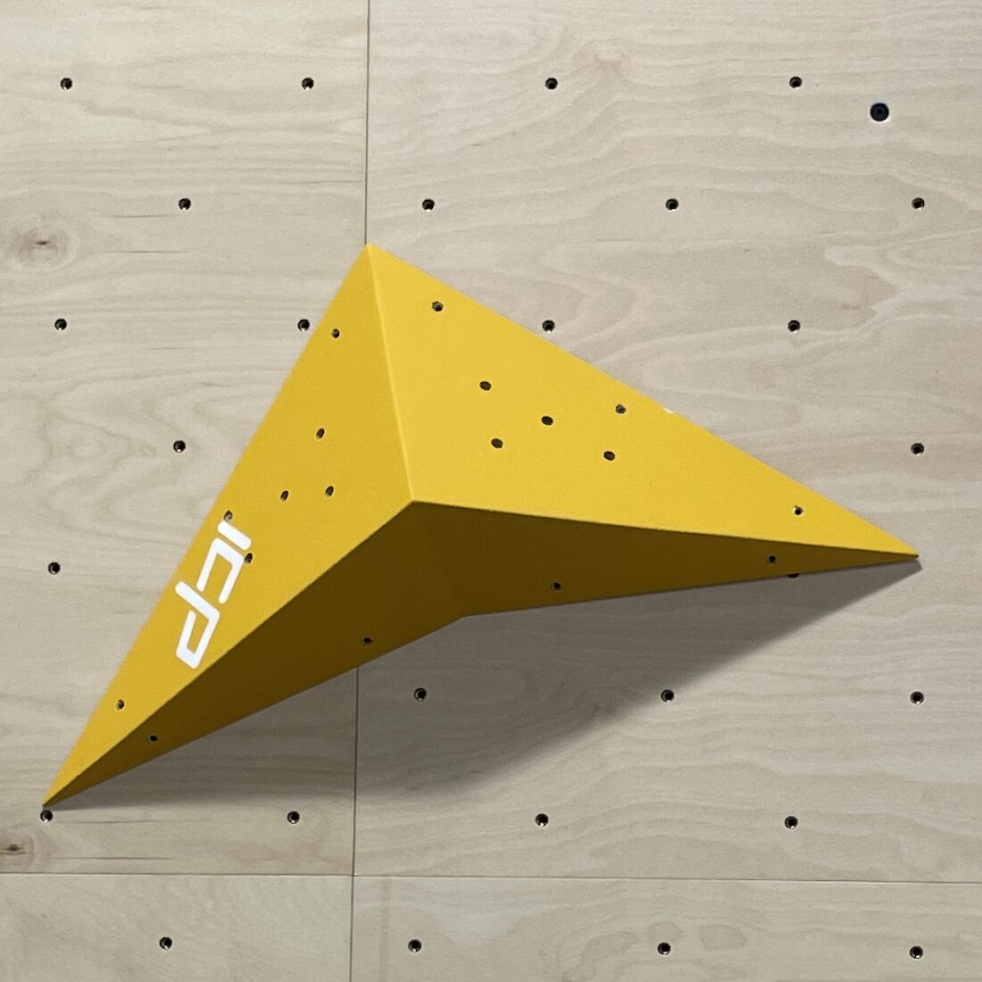 Lily.L2.3.S ICP Volume mid-sized arrowhead mounted on an indoor climbing wall for versatile route setting.