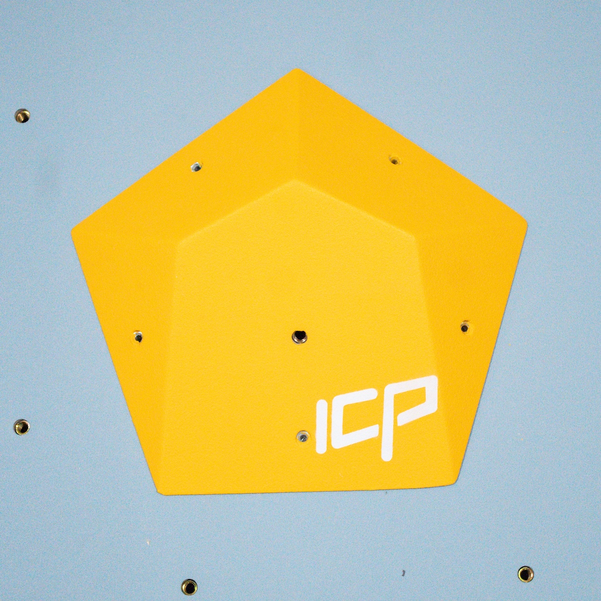 Compact yellow ICP Ivy I2.3 XS climbing volume mounted on a grey textured wall, enhancing technical route features.