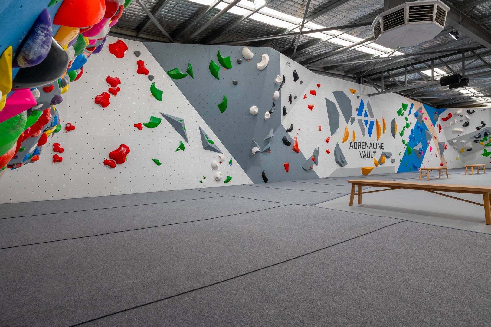 A gym built by ICP with seamless grey climbing mats.