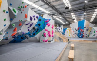 A climbing gym with many different climbing walls.