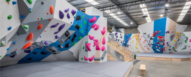 A climbing gym with many different climbing walls.