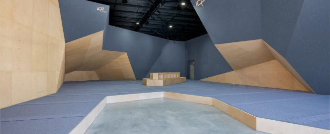 Cut Loose climbing walls freshly built by ICP with dark grey and wood textures, modern European design, and grey safety matting.