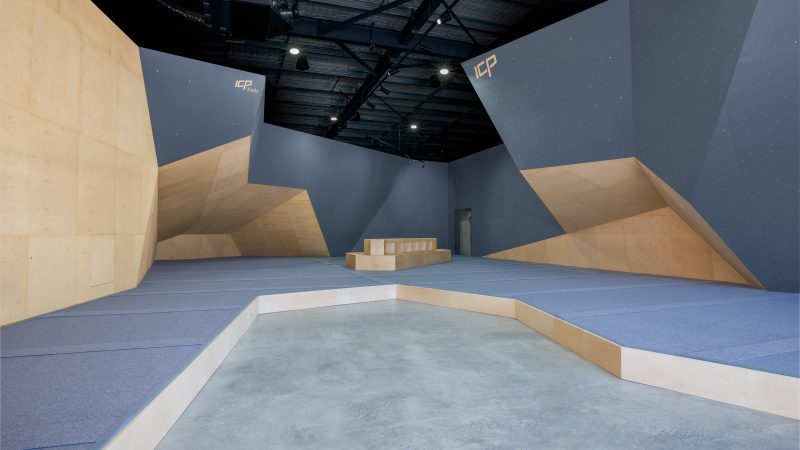 Cut Loose climbing walls freshly built by ICP with dark grey and wood textures, modern European design, and grey safety matting.
