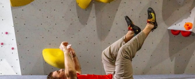 Climber falling safely onto ICP mats at an indoor bouldering gym